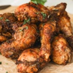 close up image of chicken drumsticks arranged in a pile.