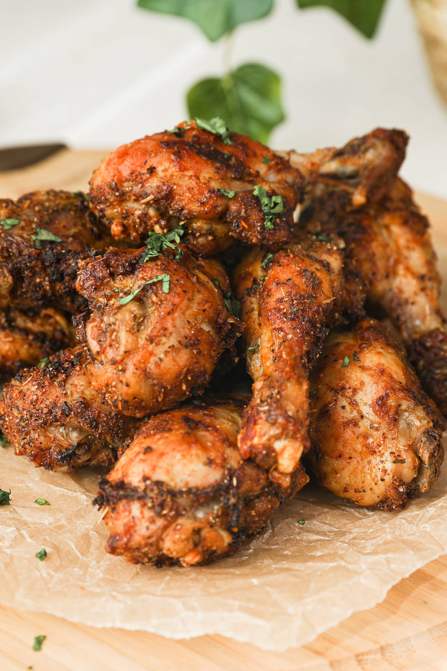close up image of chicken drumsticks arranged in a pile.
