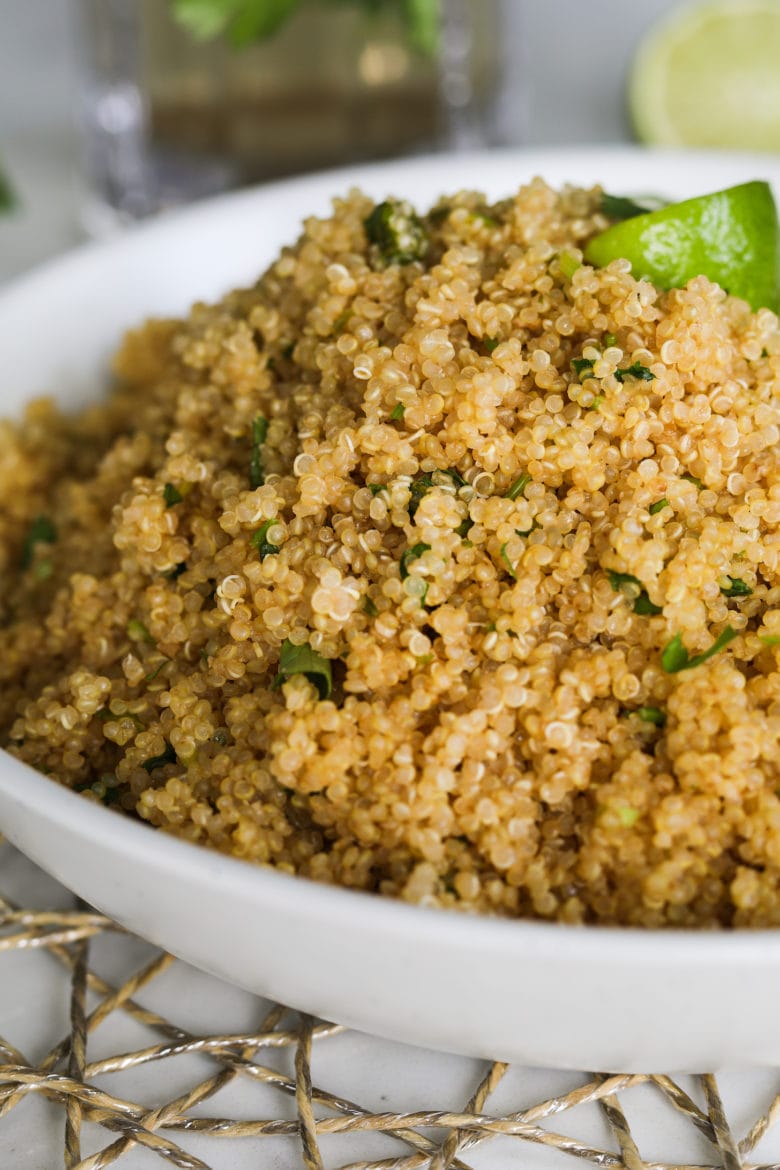 a close up of cooked quinoa with some greens embedded in it.