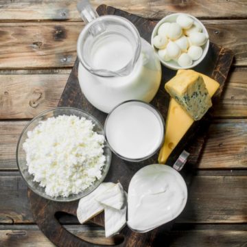 Variety of fresh dairy products. On a wooden background.
