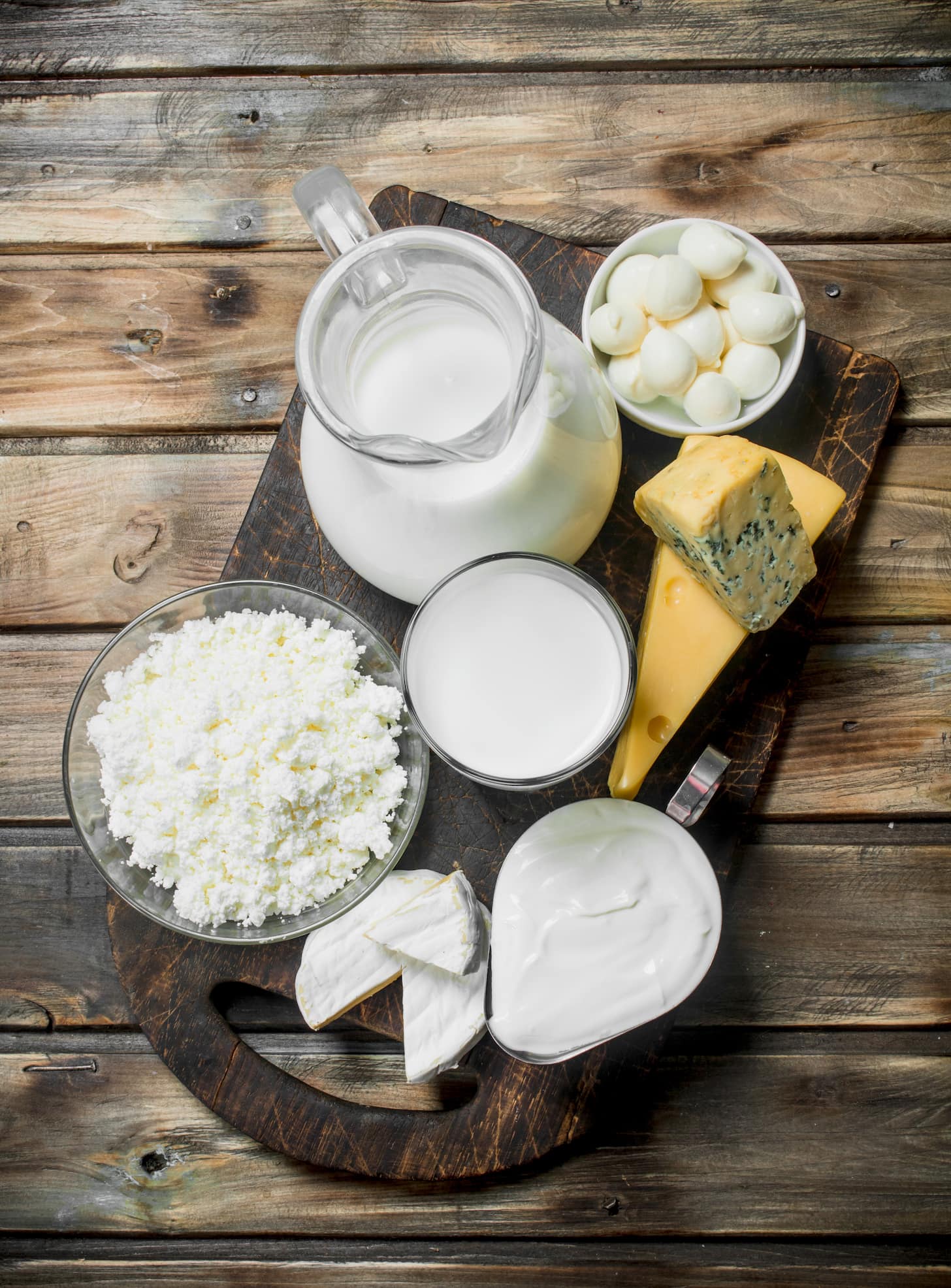 Variety of fresh dairy products. On a wooden background.