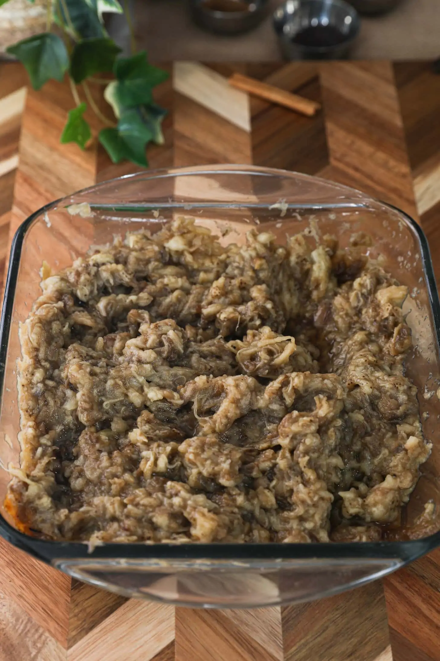 mashed eggplant in a glass square container.