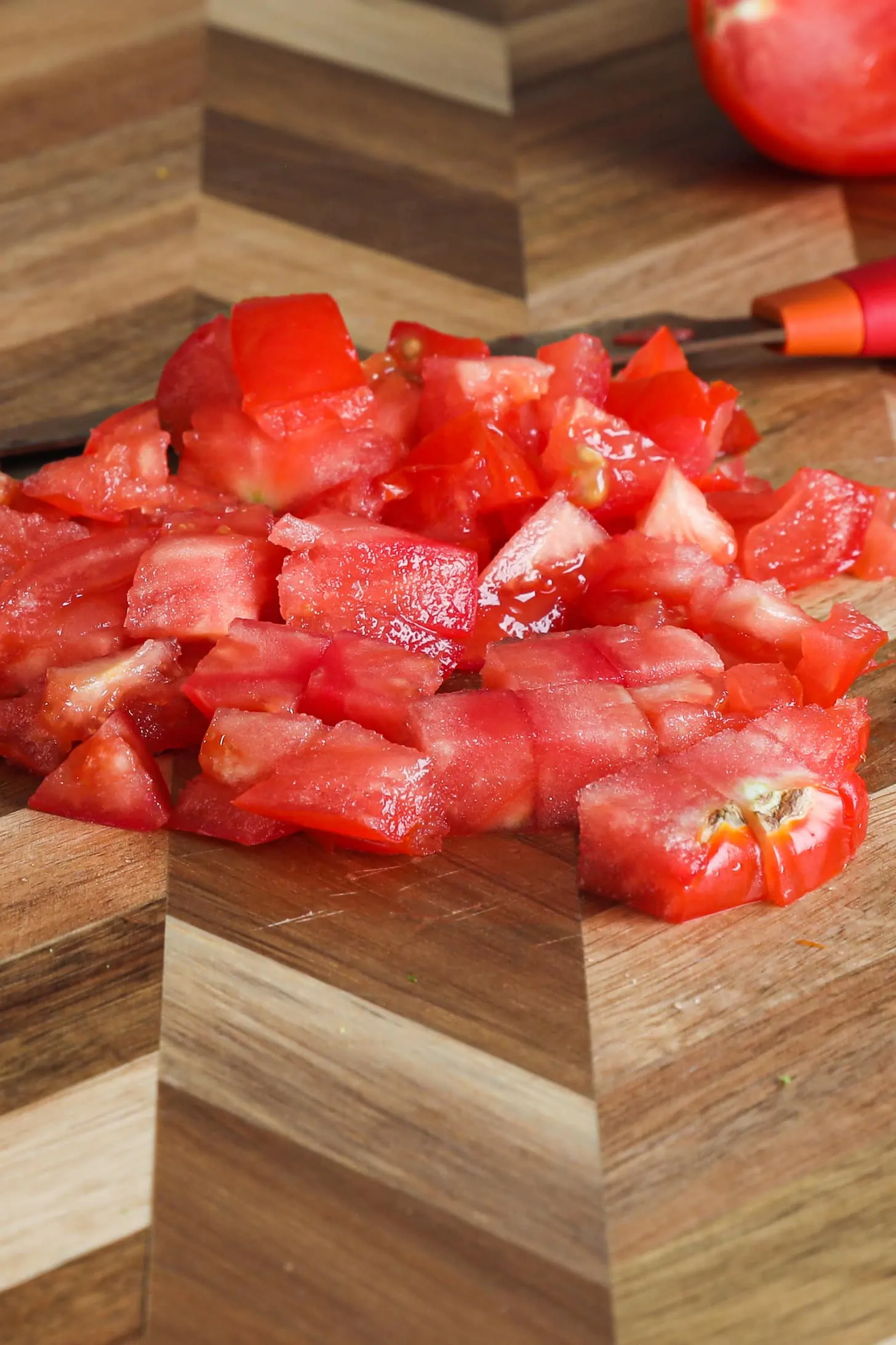 Chopped tomato on a wooden board.