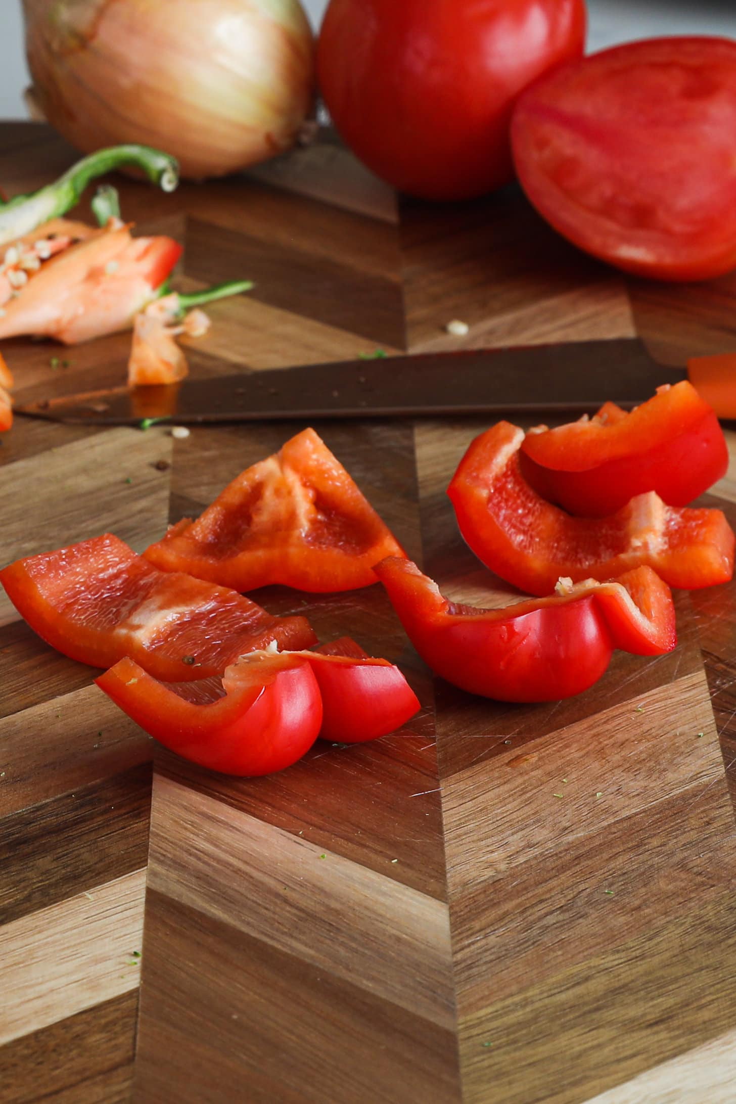 Chopped red pepper on a wooden board.