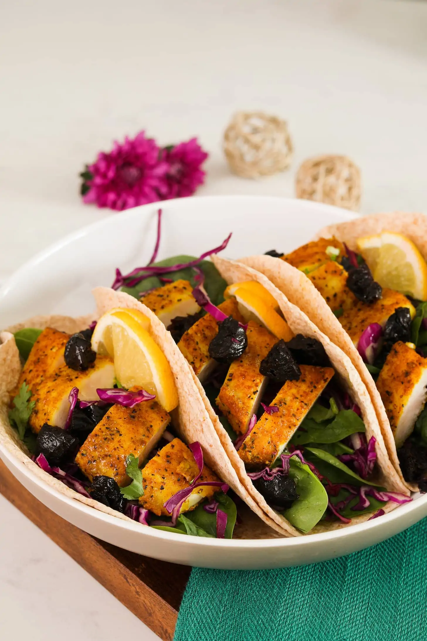 A bowl of fish tacos filled chopped prunes and vegetables.