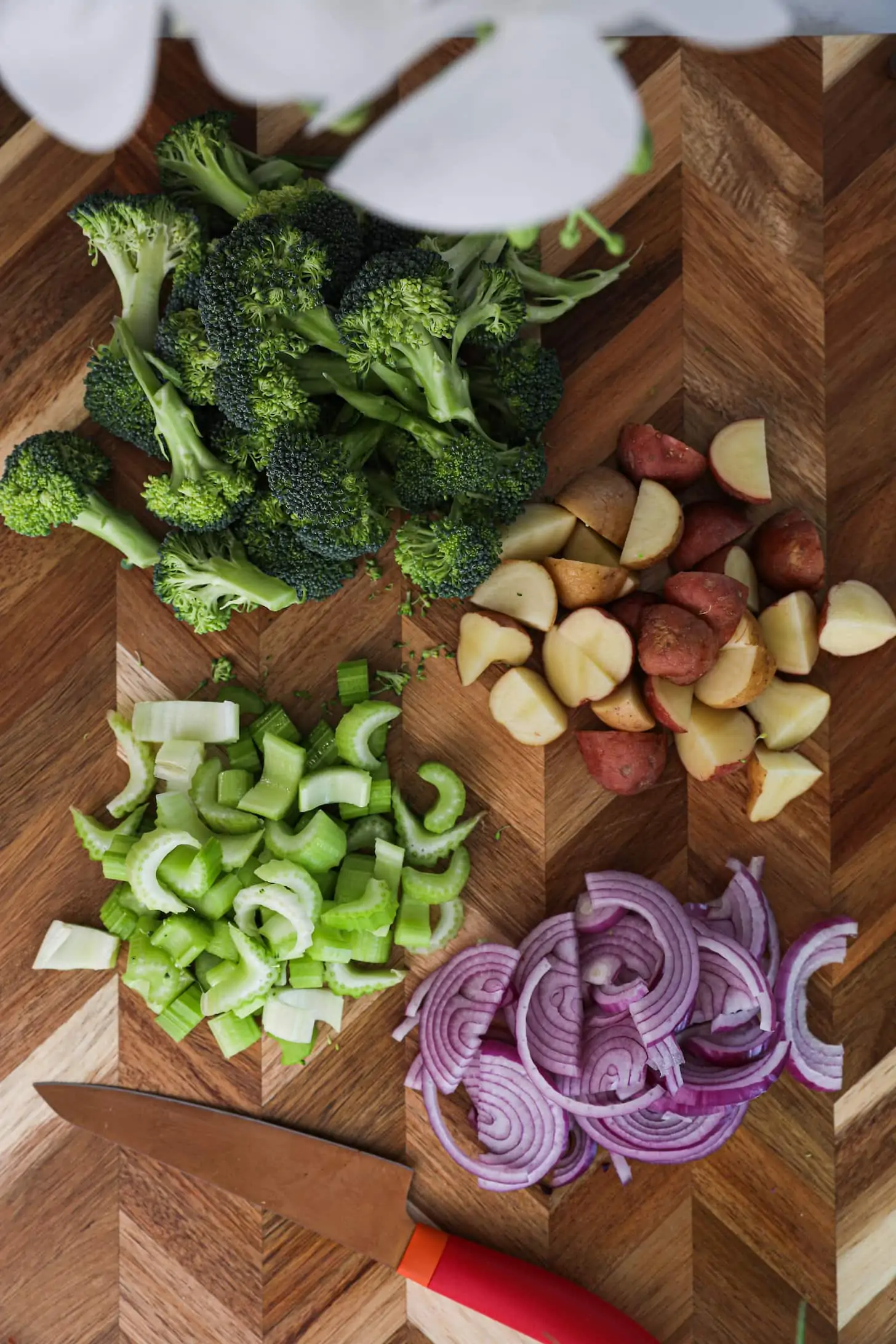 Chopped vegetables arranged on a wooden board.