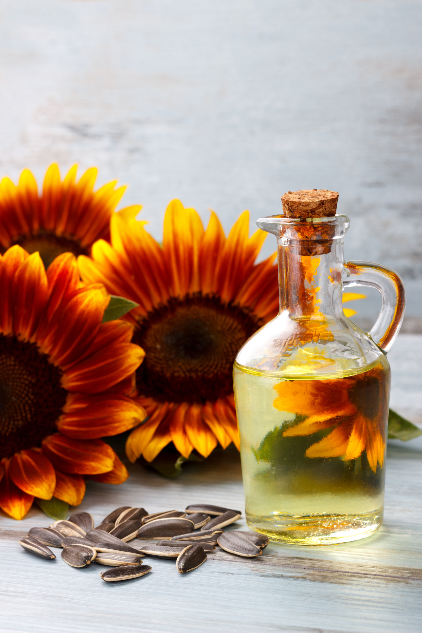 Sunflower Oil with seeds on vintage wooden background