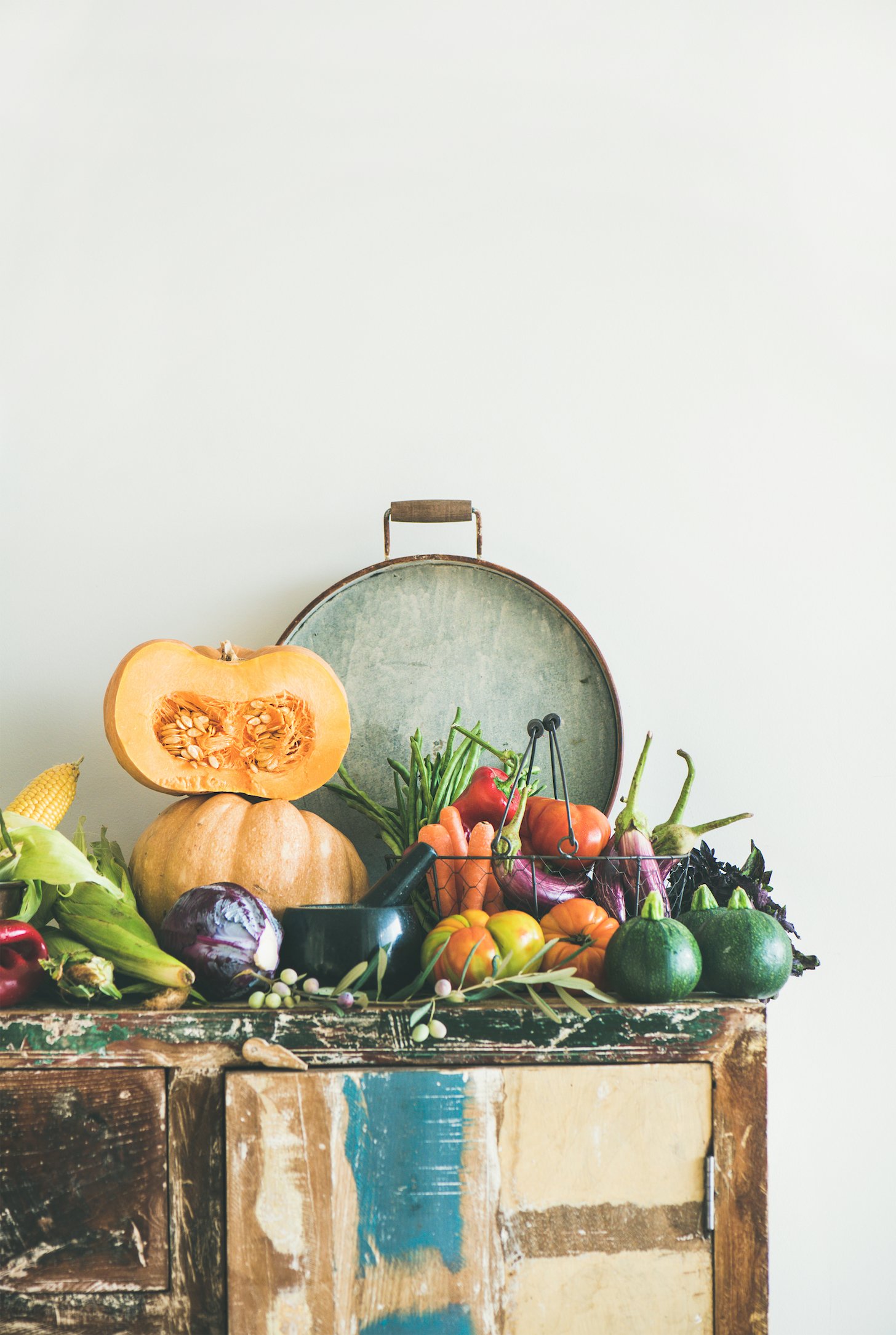 Fall vegetarian food ingredient variety. Assortment of Autumn vegetables for healthy cooking over wooden rustic cupboard.