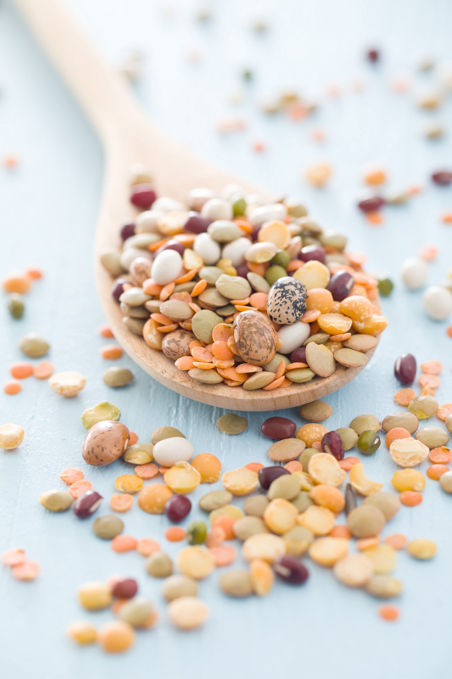 A mixture of legumes in wooden spoon.