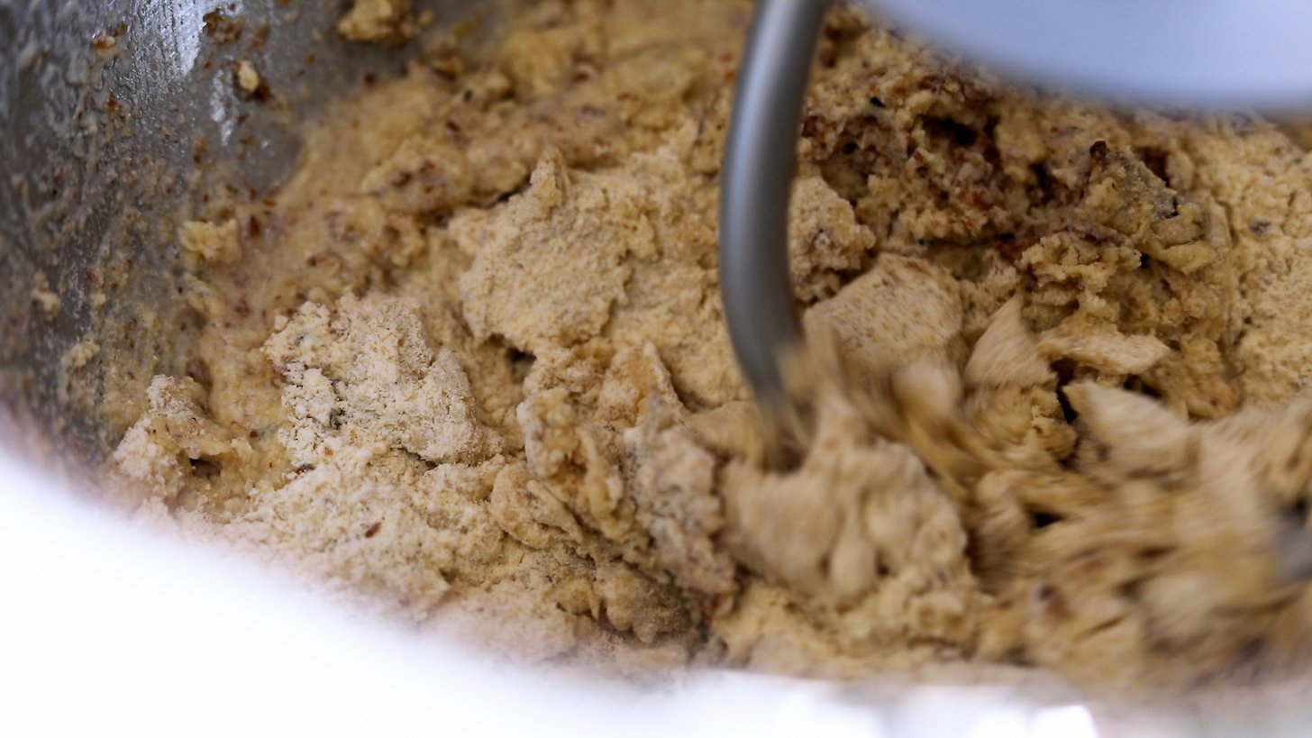 Close up of dough mixing with a stand mixer attachment.