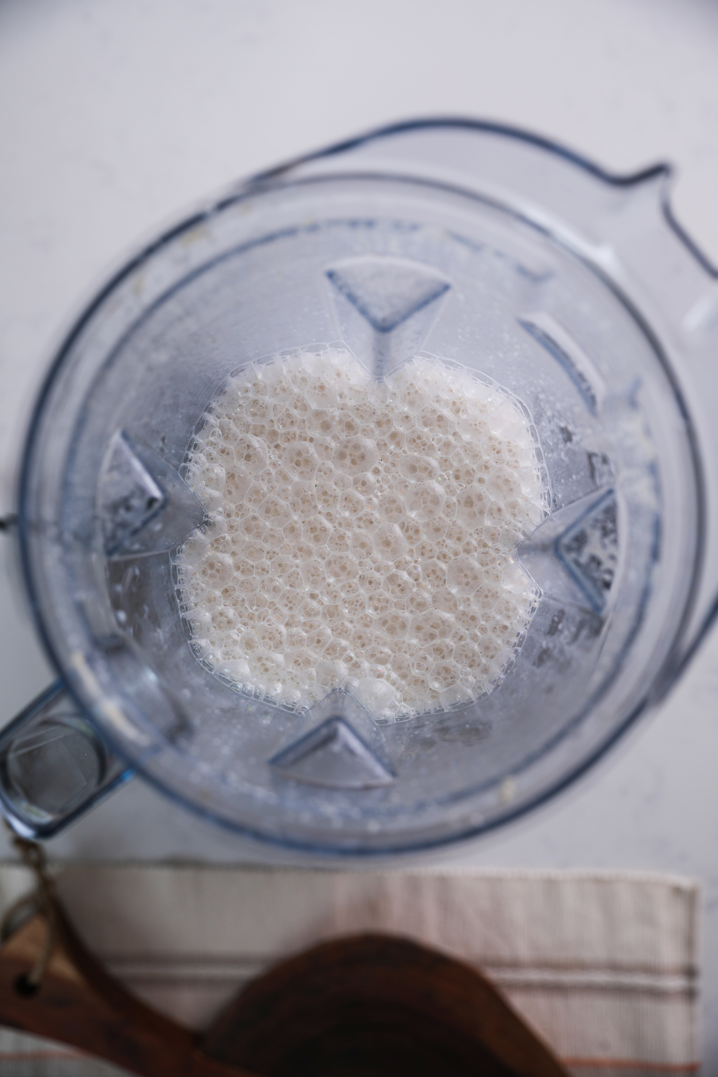 Overhead shot of a blender with frothy milk.