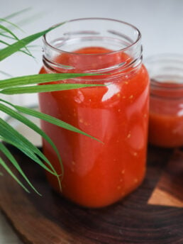 Perspective shot of a large and small jar of tomato puree.