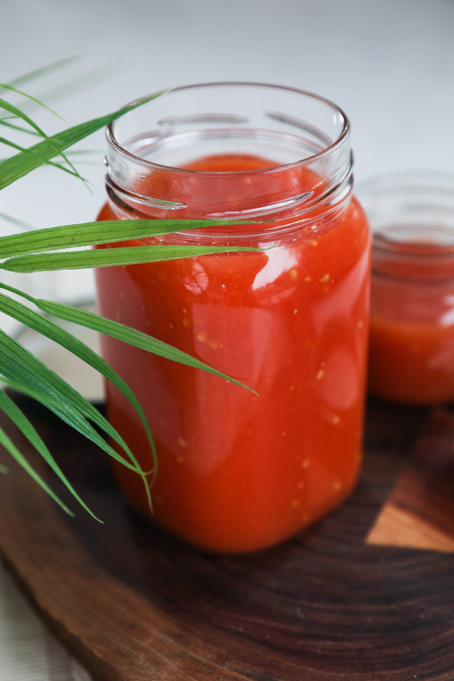 Perspective shot of a large and small jar of tomato puree.