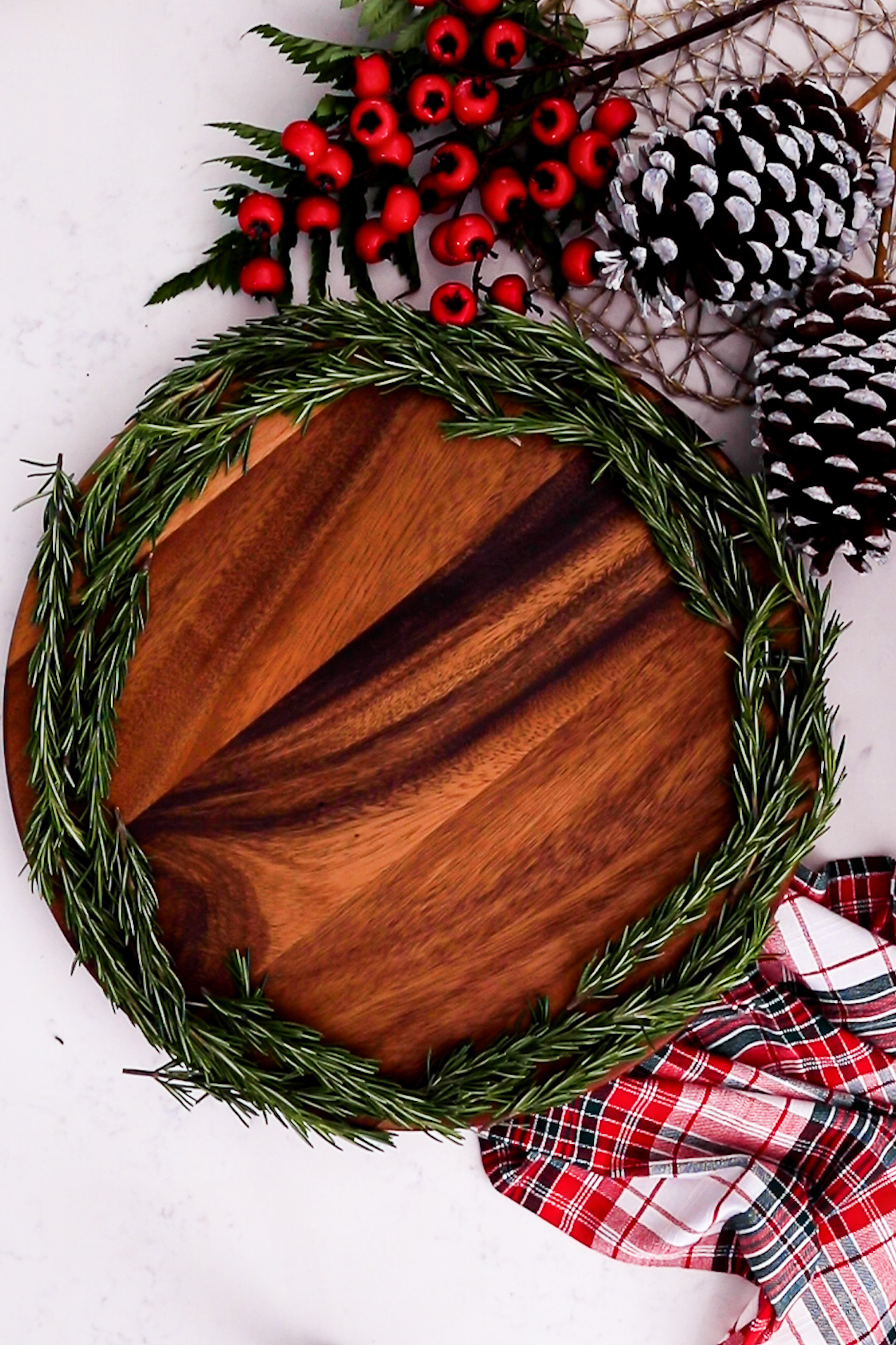 A lazy Susan holds fresh rosemary around its edge, while festive decorations surround it.