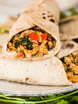 Close-up view of a single Egg Bhurji Roti Wrap placed face-up on a stack of other wraps.