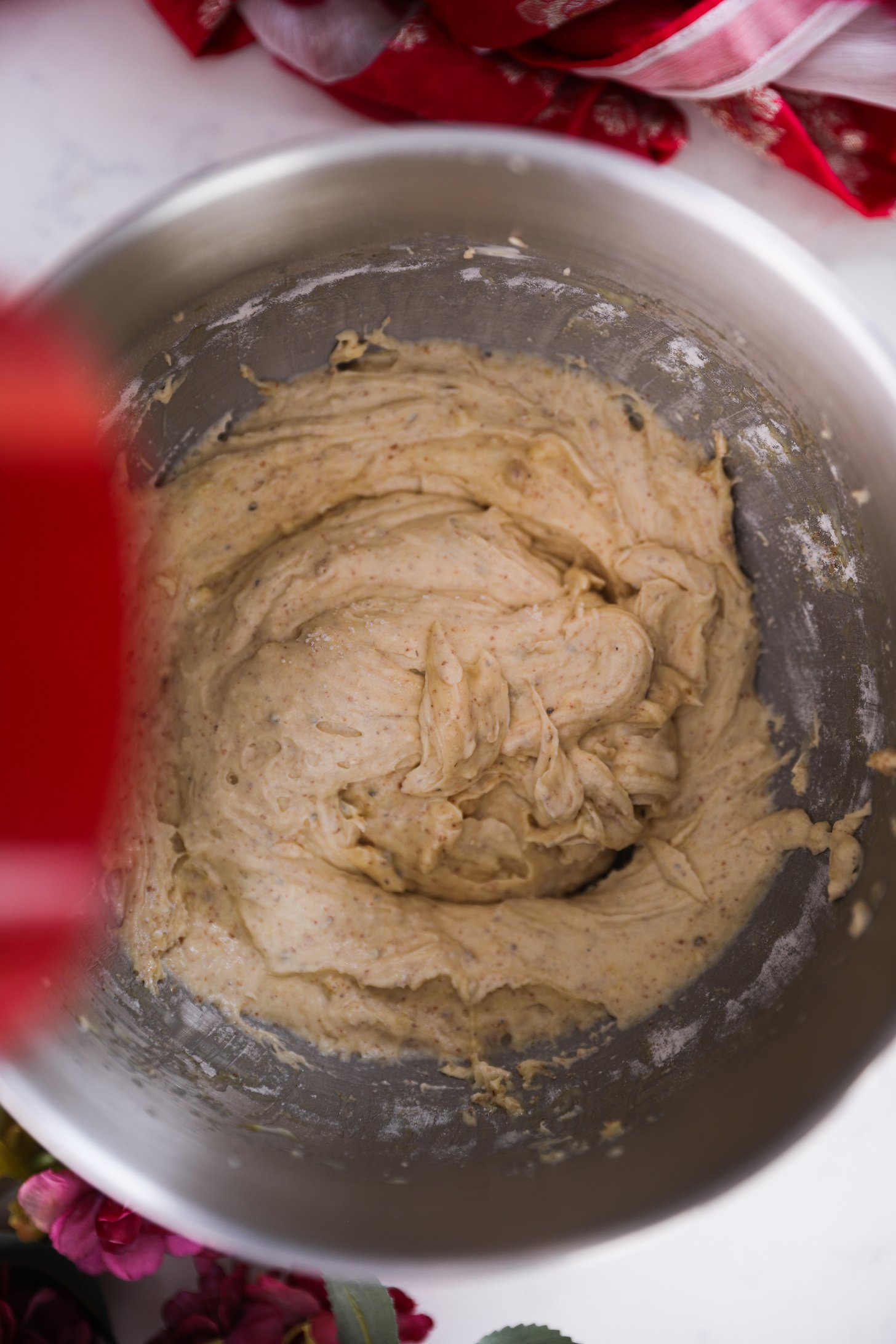 An overhead shot reveals a stand mixer bowl containing a thick cake batter.