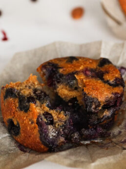 Close-up image of a blueberry muffin torn in half.