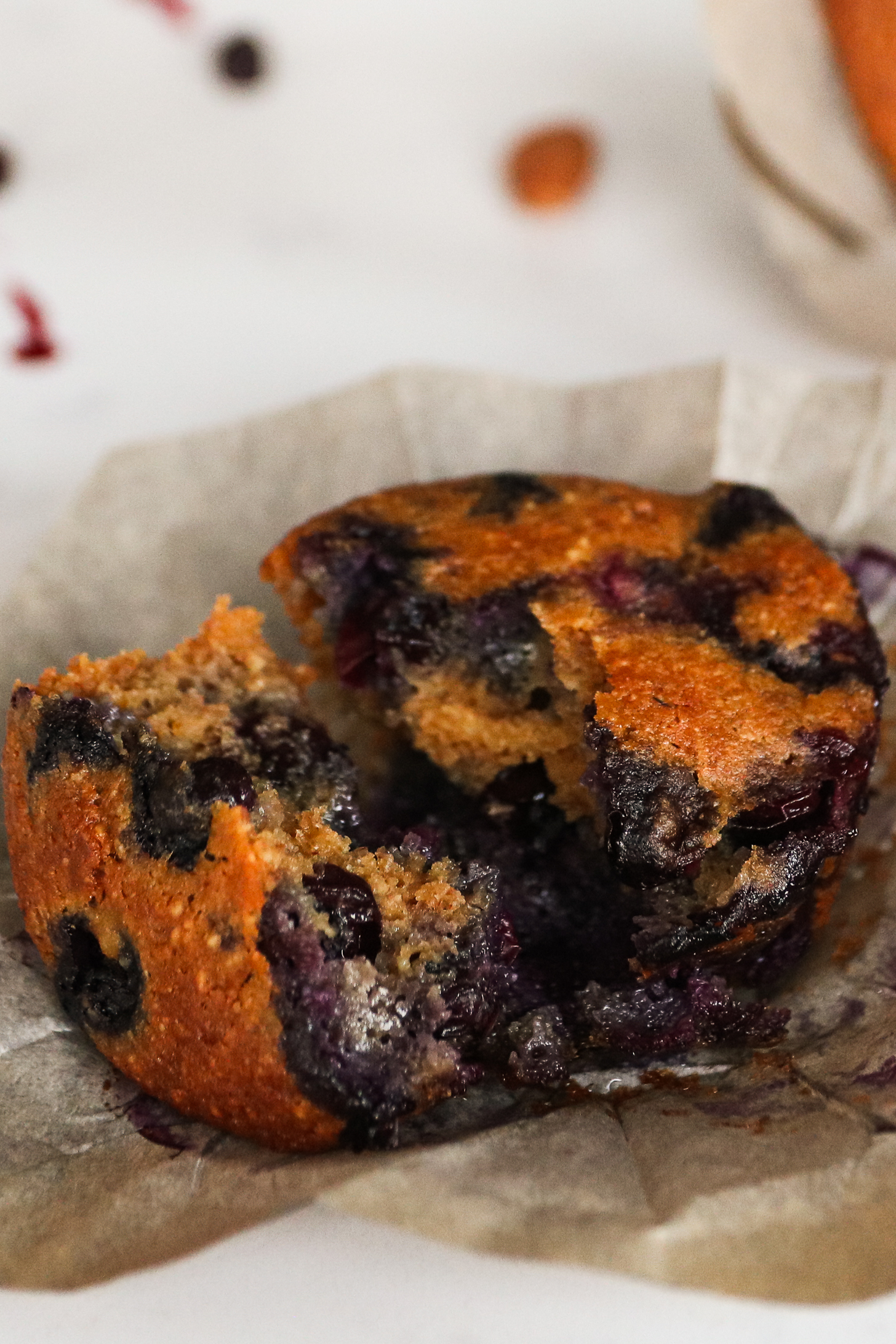 Close-up image of a blueberry muffin torn in half.
