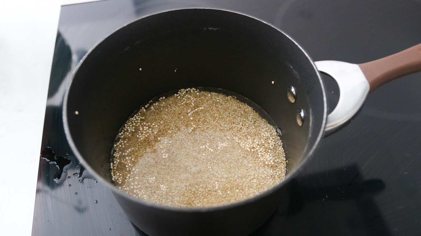 A saucepan with quinoa submerged in water.