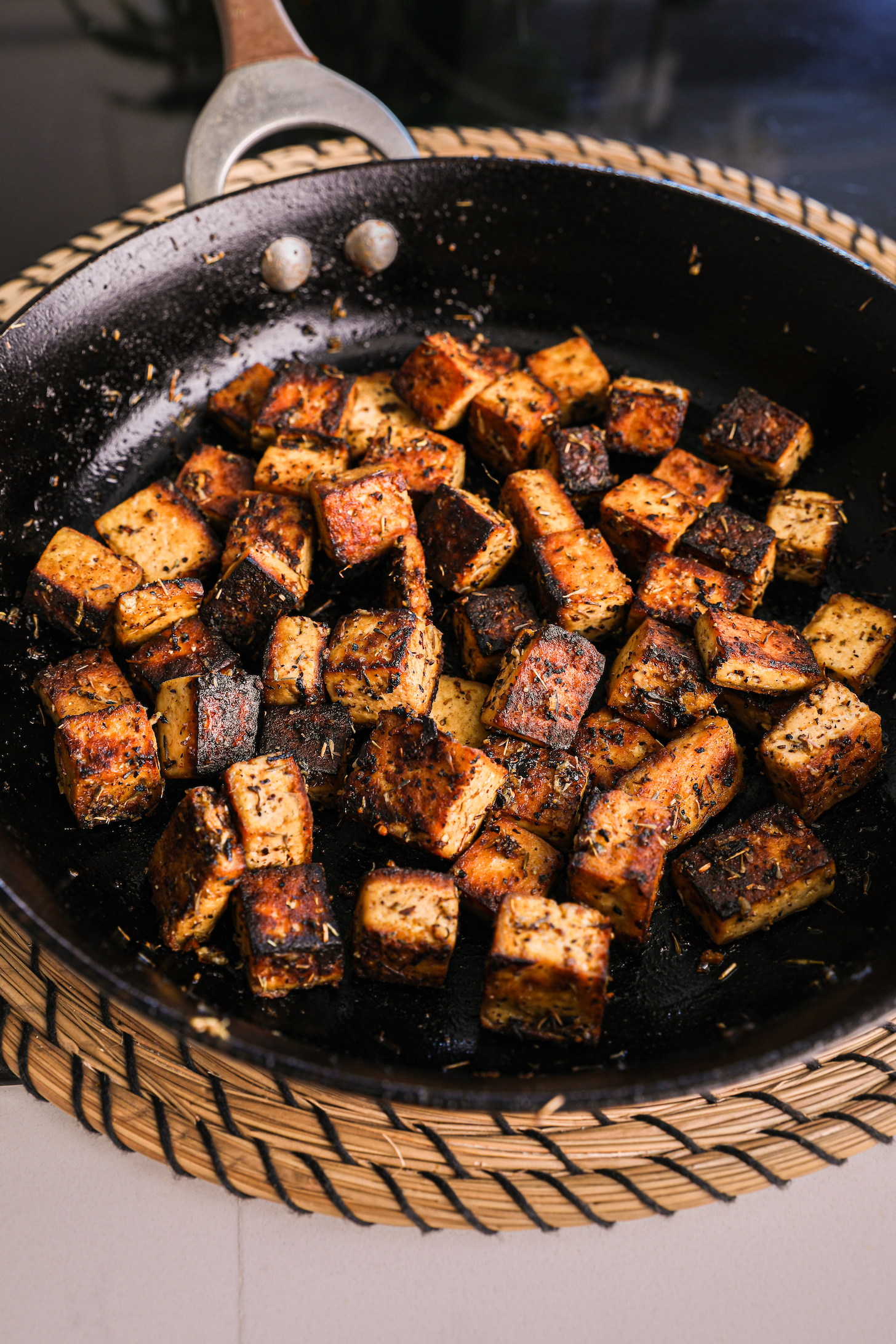 Perspective view of pan with golden crispy tofu cubes.