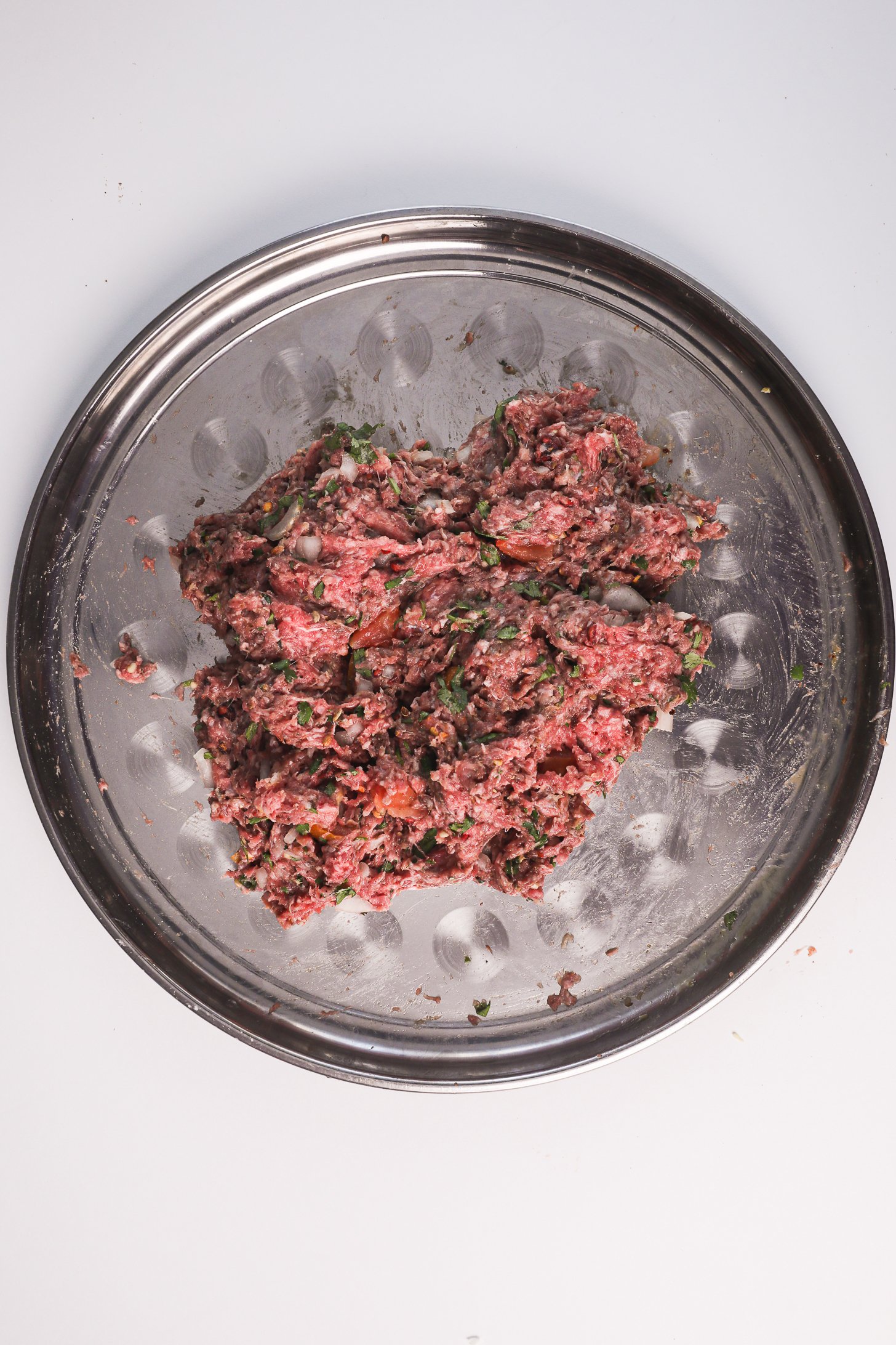 Mixed Chapli Kebab ingredients in a tray.