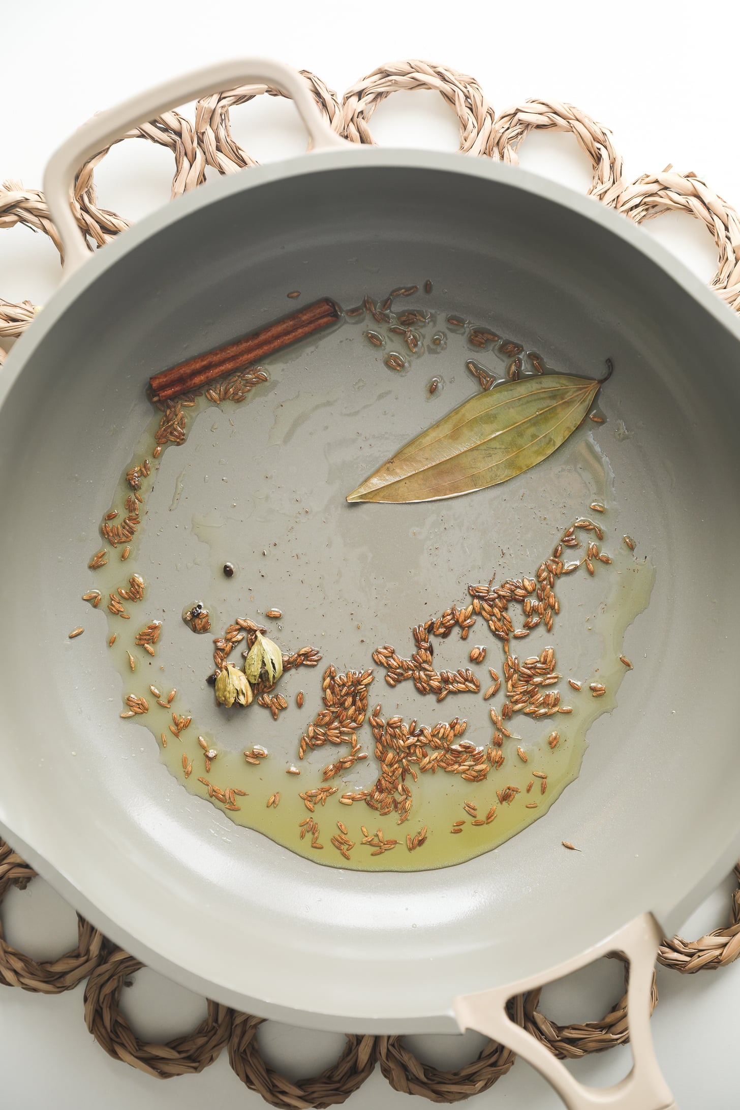Oil and spices in the pan after flowering.